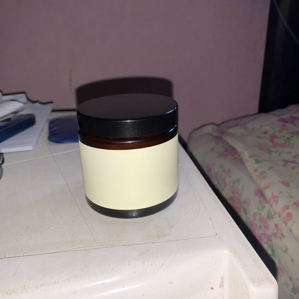 A jar of shea body butter, as a phone photo and as a finished studio frame